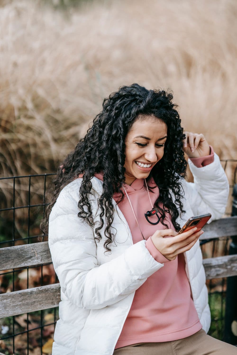 A woman looking at her phone and smiling